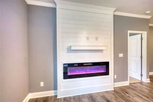 a room with a wooden floor and a fireplace