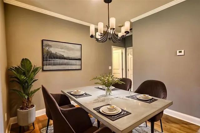 a view of a dining room with furniture wooden floor and chandelier