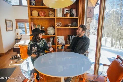 a view of a living room with furniture and wooden floor