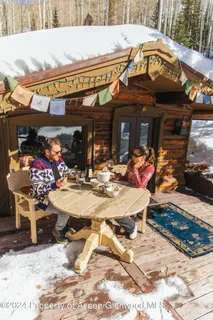 a view of a cafe with a table and chairs in the patio