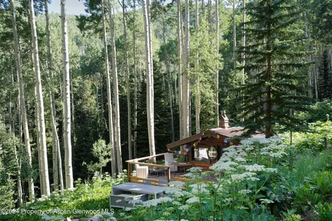 a view of a chair and table in the garden