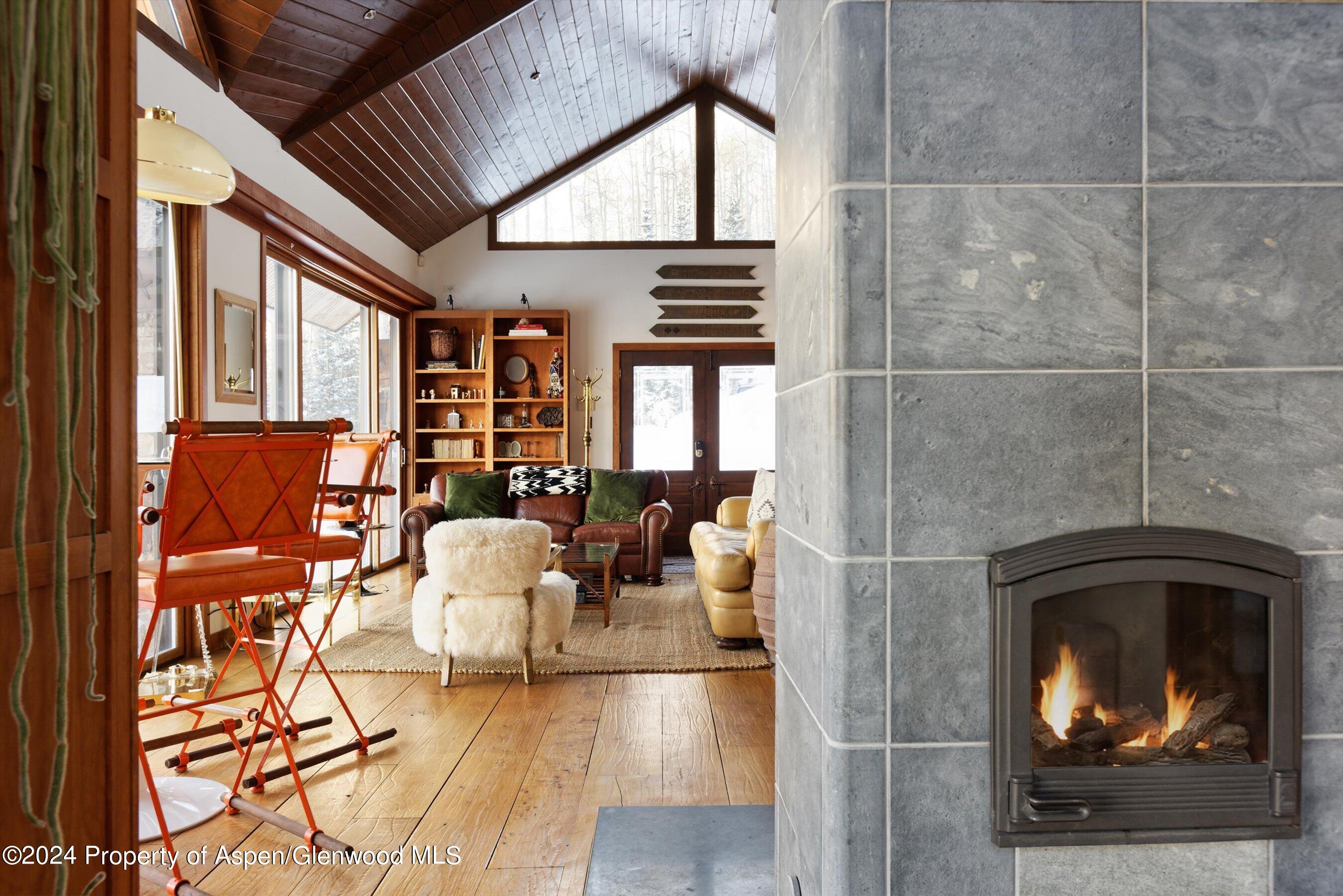 88 S Meadow Aspen, CO 81612 - Photo 2 of 40 a living room with furniture a fireplace and a floor to ceiling window