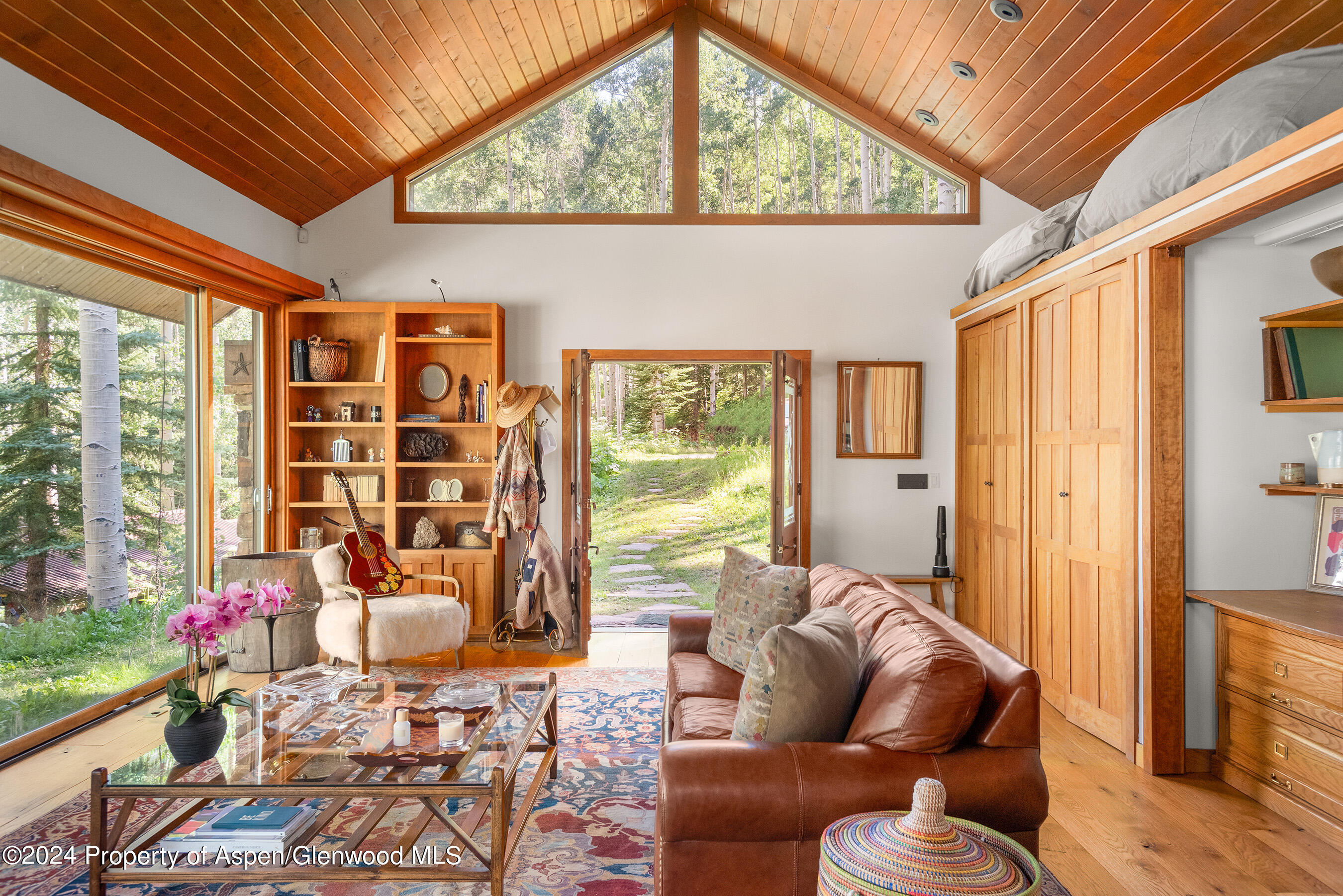 88 S Meadow Aspen, CO 81612 - Photo 21 of 40 a living room with furniture and a floor to ceiling window