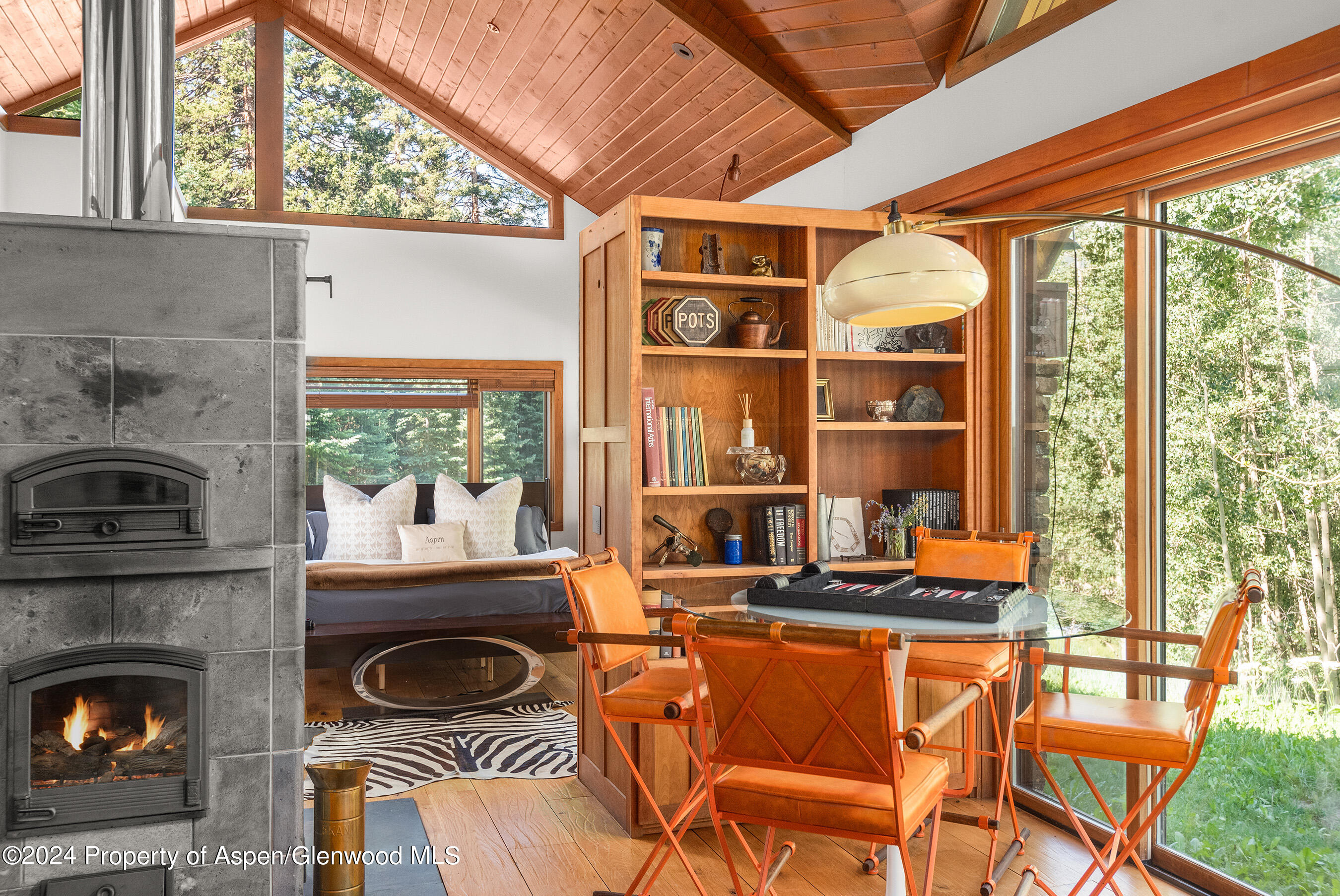 88 S Meadow Aspen, CO 81612 - Photo 30 of 40 a dining room with a fireplace a flat screen tv and outdoor view