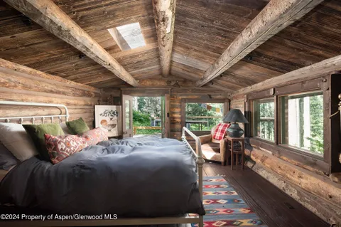 a bed room with a bed and a large window