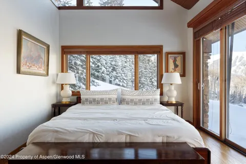a bedroom with a large bed and a large window