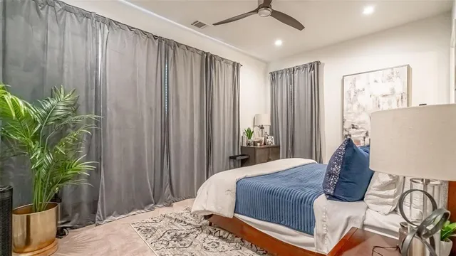 a bedroom with a bed and a potted plant