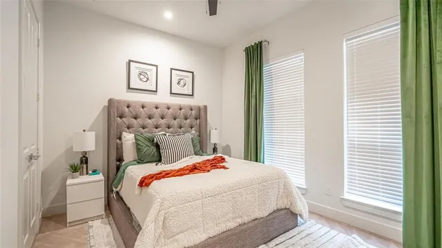 a bedroom with a bed and a painting on the wall