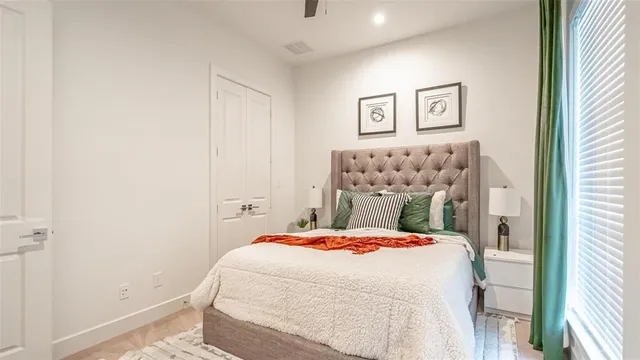 a bedroom with a bed and a painting on the wall