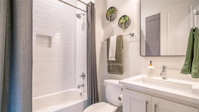 a bathroom with a sink mirror vanity and toilet