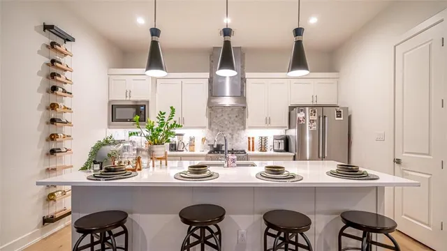 a kitchen with sink and chairs