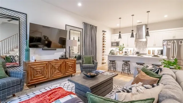 a living room with furniture and a view of kitchen