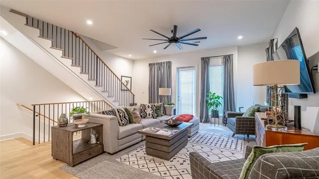 a living room with furniture and a wooden floor