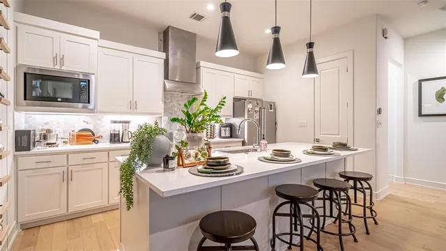 a kitchen with a sink stove and white cabinets