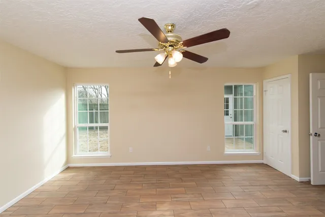 a view of a yard with wooden fence