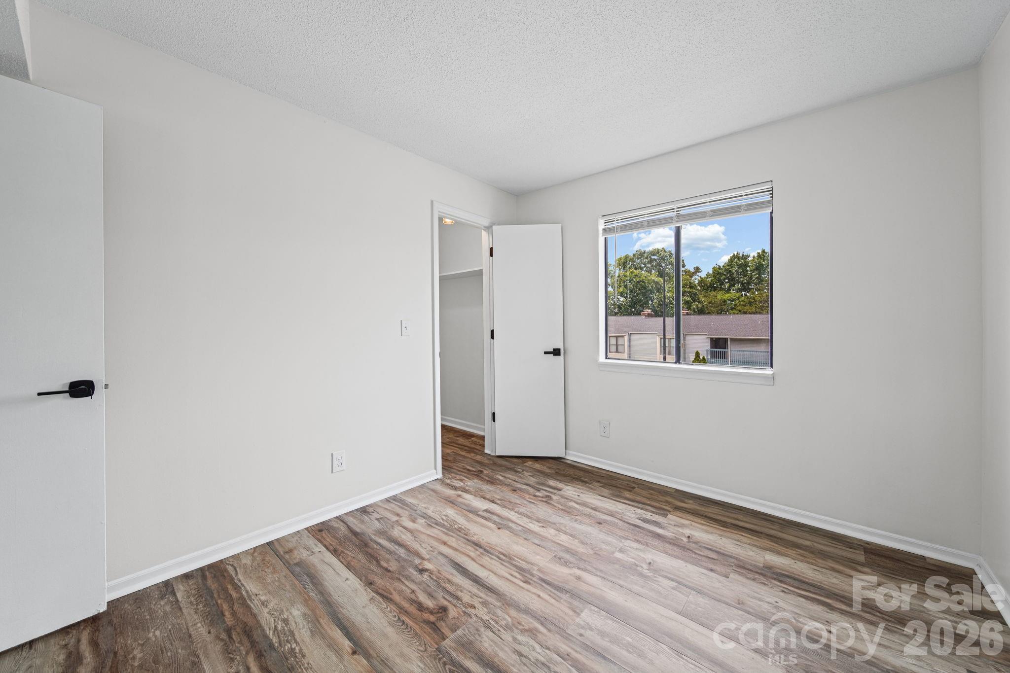11023 Harrowfield Road Charlotte, NC 28226 - Photo 28 of 32 a view of room with window and hardwood floor
