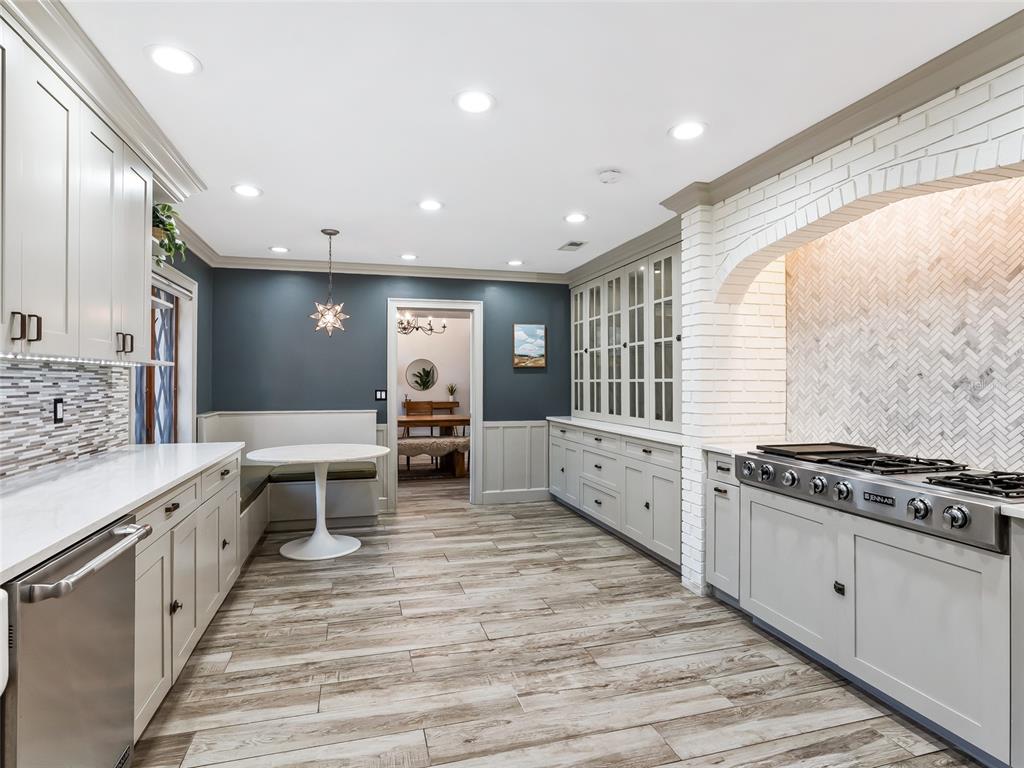 680 Southeast 123rd Street Road Ocala, FL 34480 - Photo 17 of 48 a large white kitchen with stainless steel appliances granite countertop a stove and a sink