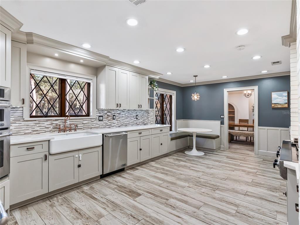 680 Southeast 123rd Street Road Ocala, FL 34480 - Photo 18 of 48 a large bathroom with double vanity sinks a large mirror and a next to a window