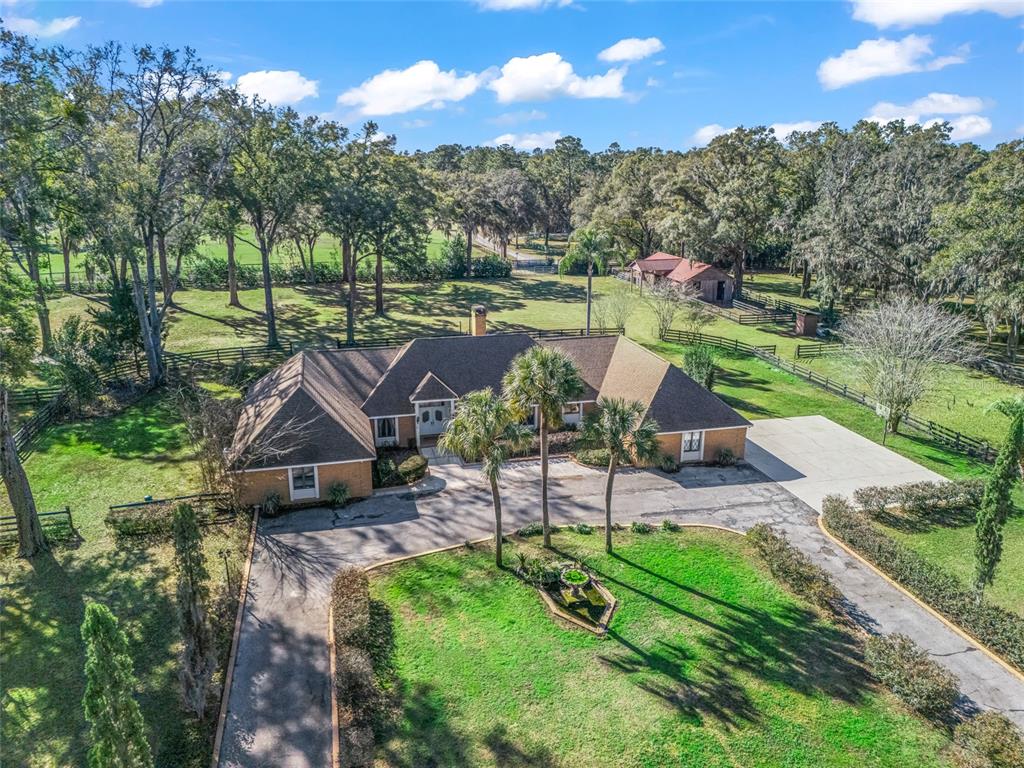 680 Southeast 123rd Street Road Ocala, FL 34480 - Photo 2 of 48 a view of a garden with plants and lake view