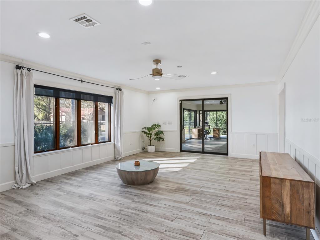 680 Southeast 123rd Street Road Ocala, FL 34480 - Photo 21 of 48 a view of an empty room with wooden floor and a window
