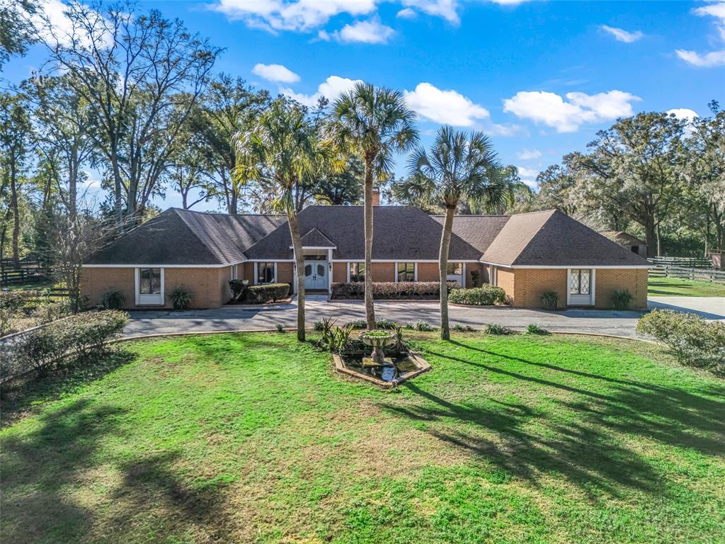 680 Southeast 123rd Street Road Ocala, FL 34480 - Photo 3 of 48 a view of a house with backyard and a sitting area