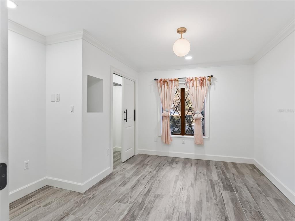 680 Southeast 123rd Street Road Ocala, FL 34480 - Photo 31 of 48 wooden floor in an empty room with a window