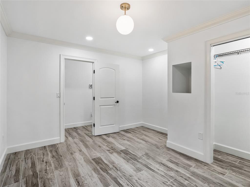 680 Southeast 123rd Street Road Ocala, FL 34480 - Photo 32 of 48 wooden floor in an empty room with a window
