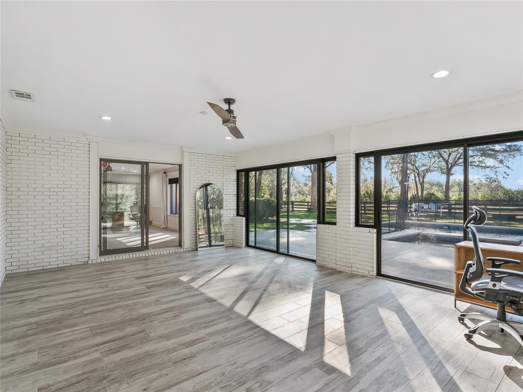 680 Southeast 123rd Street Road Ocala, FL 34480 - Photo 33 of 48 a view of a room with gym equipment and large window
