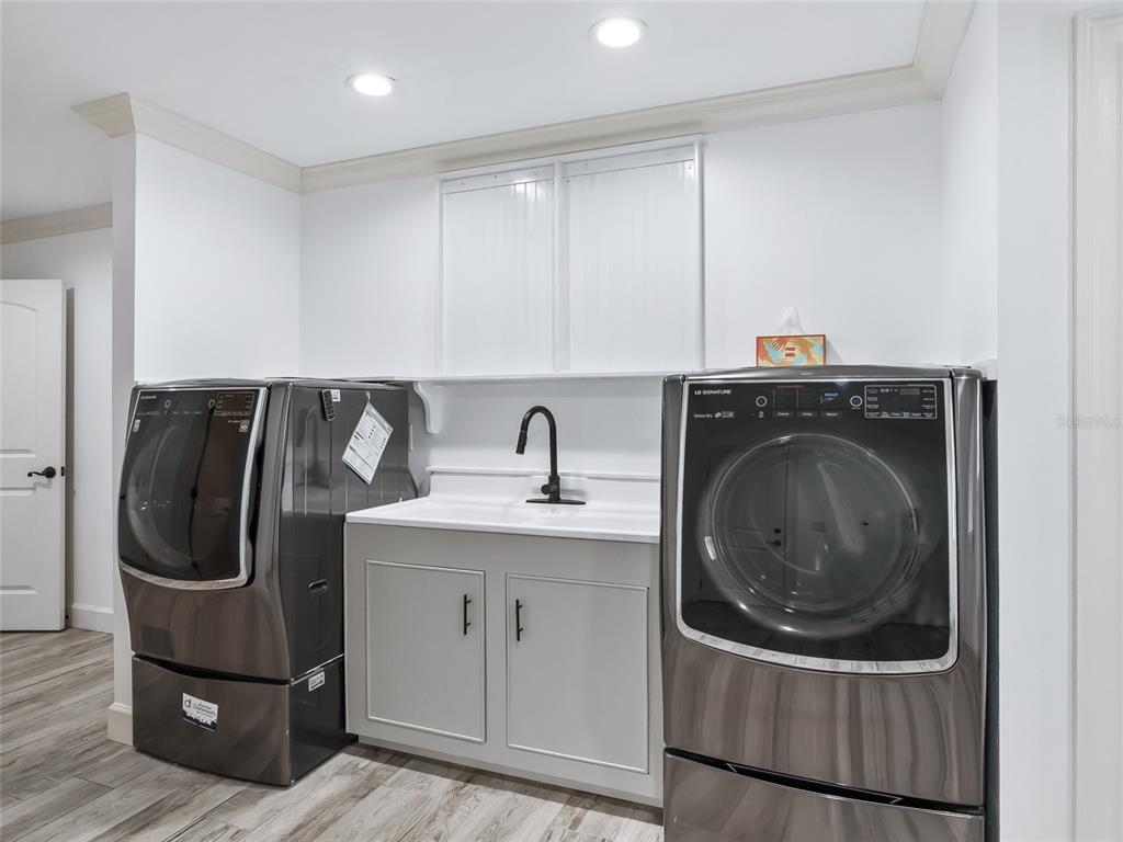 680 Southeast 123rd Street Road Ocala, FL 34480 - Photo 34 of 48 a utility room with sink dryer and washer