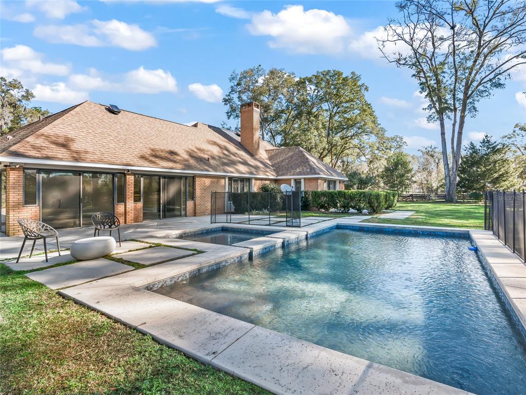 680 Southeast 123rd Street Road Ocala, FL 34480 - Photo 36 of 48 a view of pool with table and chairs under an umbrella
