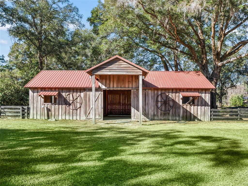 680 Southeast 123rd Street Road Ocala, FL 34480 - Photo 44 of 48 a front view of a house with a yard table and trees