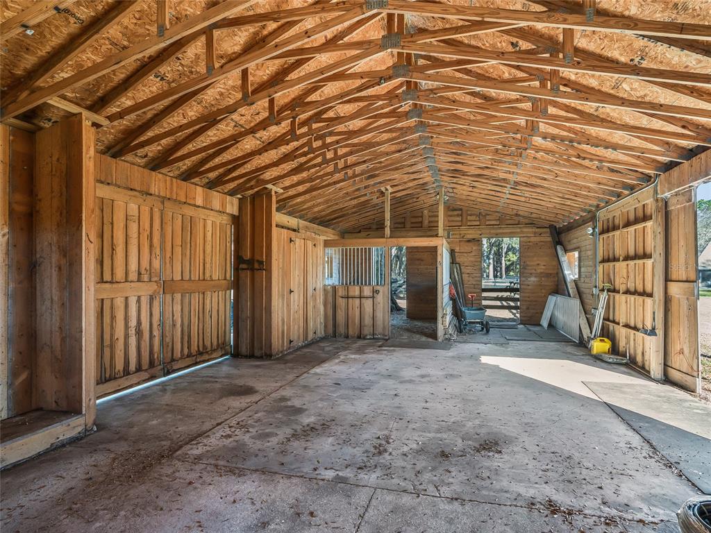 680 Southeast 123rd Street Road Ocala, FL 34480 - Photo 45 of 48 a view of an empty room with wooden walls