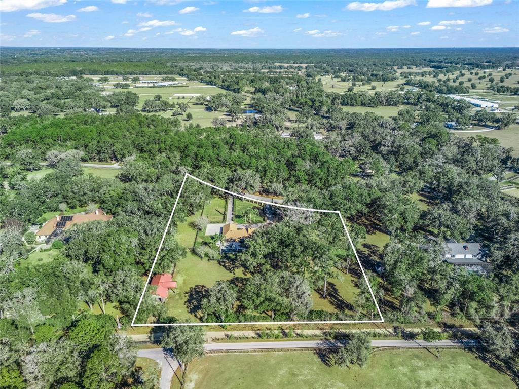 680 Southeast 123rd Street Road Ocala, FL 34480 - Photo 47 of 48 a view of a garden with a lake