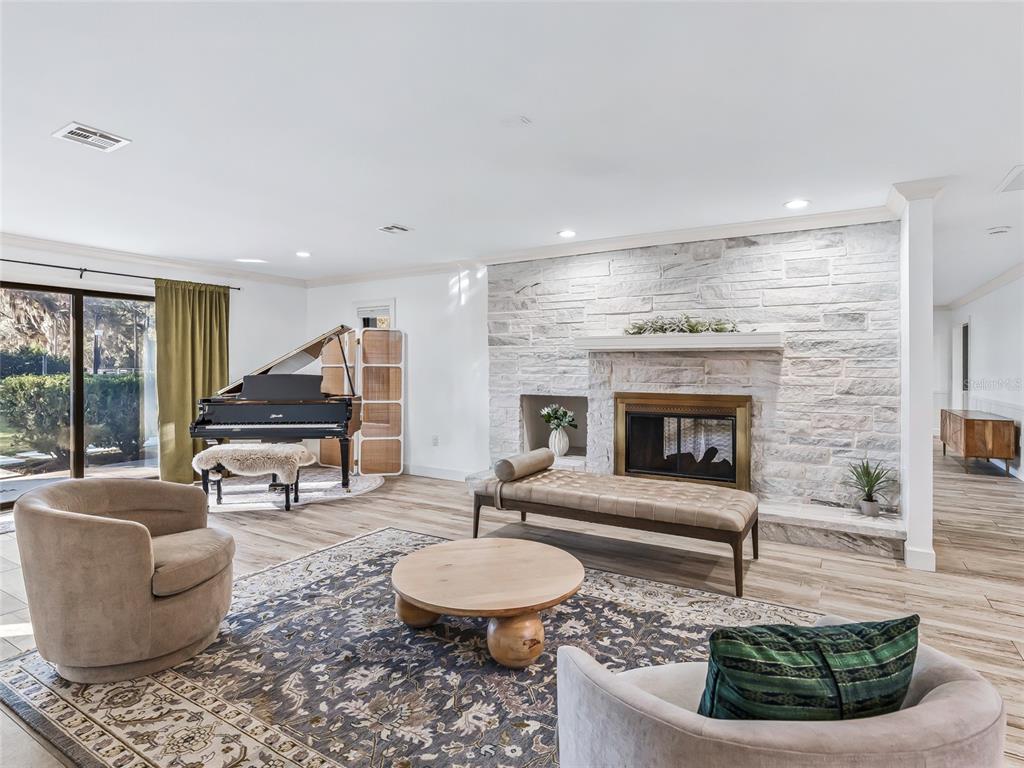 680 Southeast 123rd Street Road Ocala, FL 34480 - Photo 8 of 48 a living room with furniture and a fireplace
