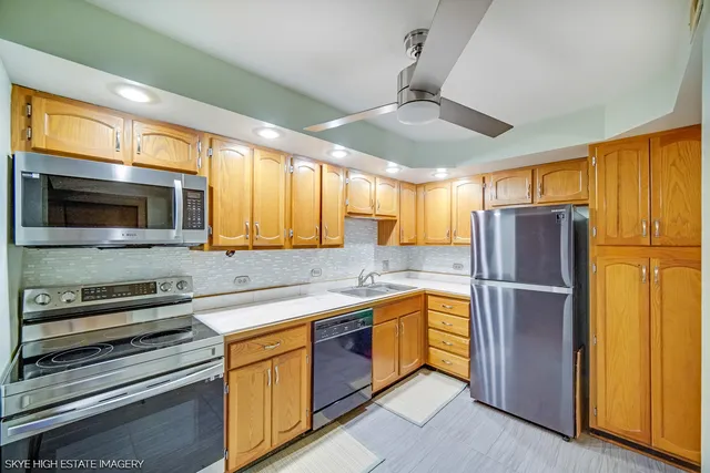 a kitchen with stainless steel appliances granite countertop a refrigerator and a sink
