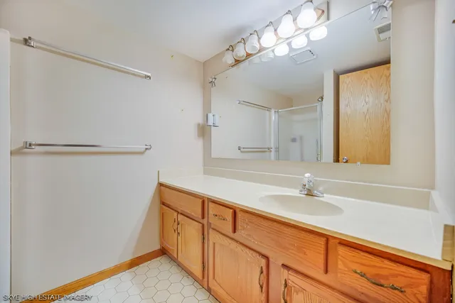 a bathroom with a sink double vanity and a mirror