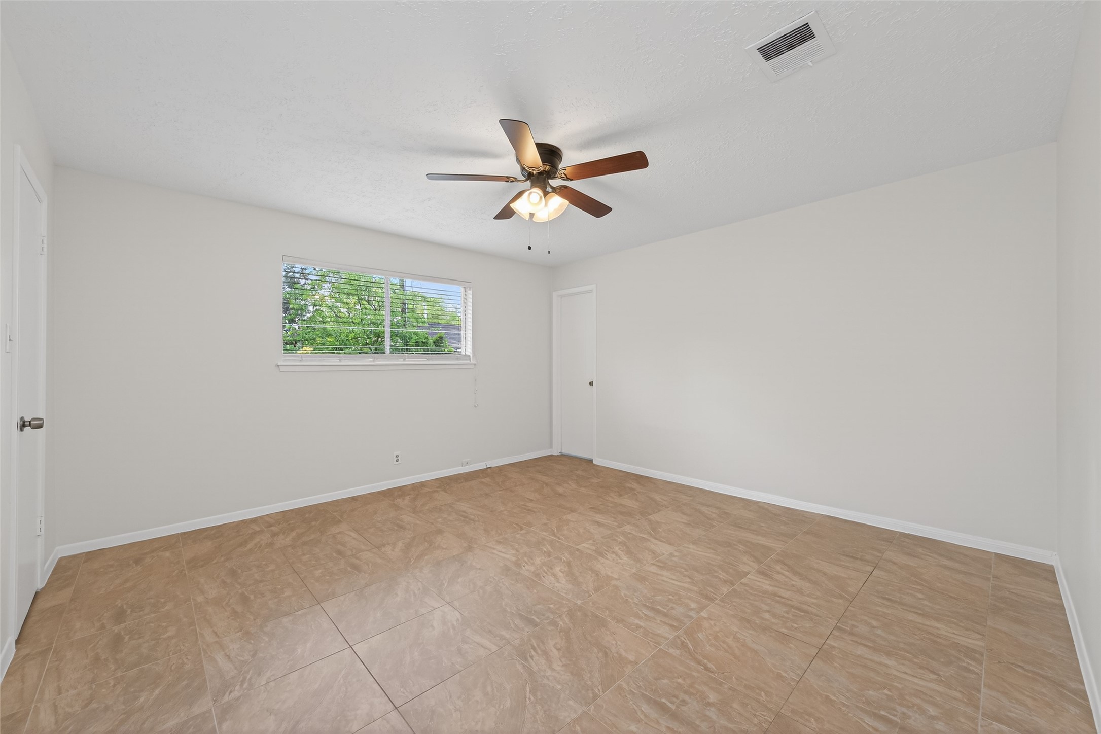 23919 Farm Hill Drive Spring, TX 77373 - Photo 27 of 41 an empty room with windows and fan