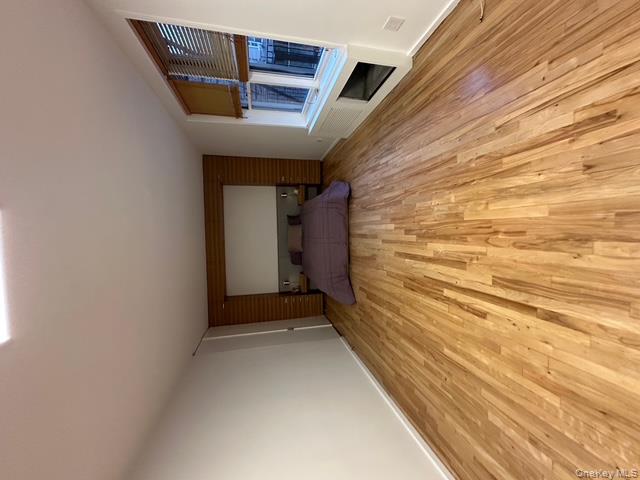Unfurnished bedroom with light wood-type flooring and baseboards