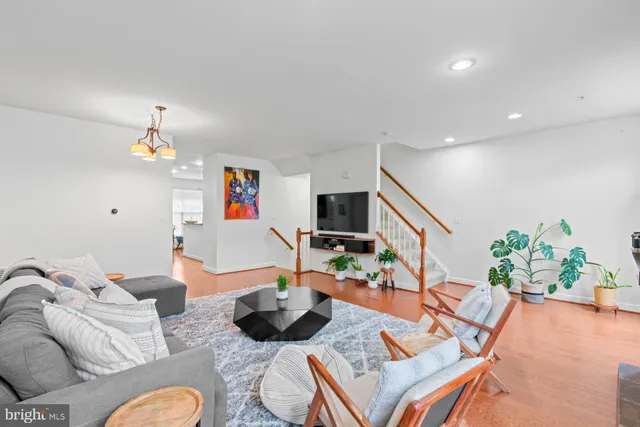 a living room with furniture and a chandelier