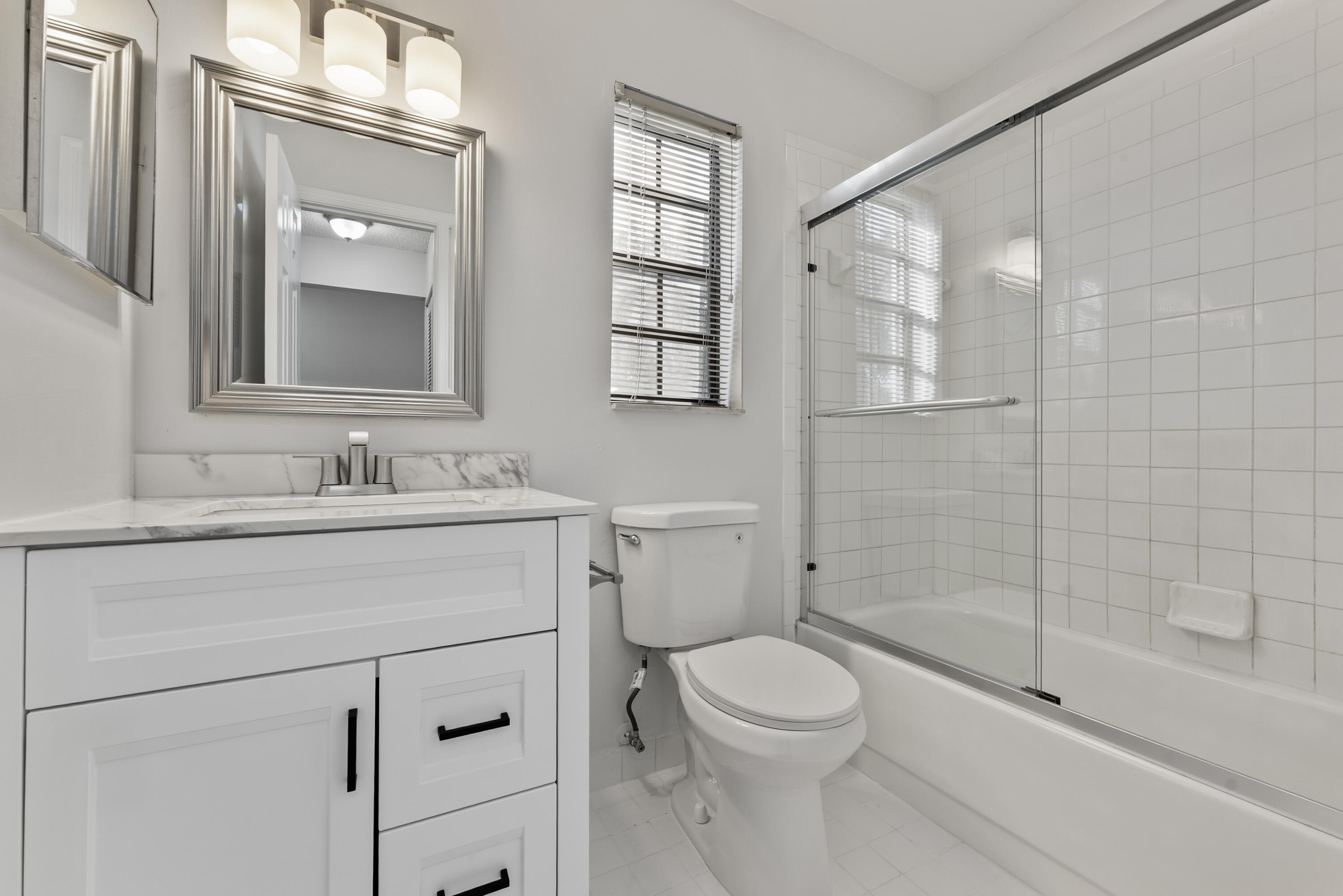 2900 Olivewood Terrace, Unit 2010 Boca Raton, FL 33431 - Photo 7 of 22 a bathroom with a sink a toilet and shower