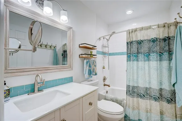 a kitchen with granite countertop white cabinets and a sink
