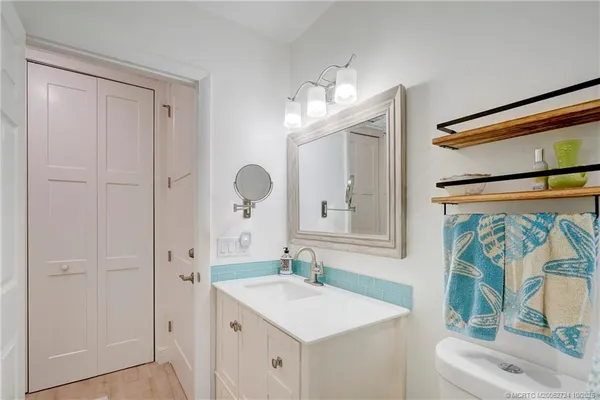 a kitchen with granite countertop a sink appliances cabinets and a counter top space