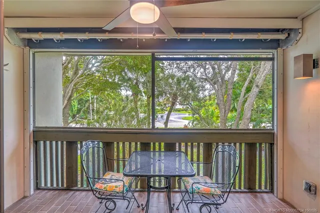 a view of a white house with a yard