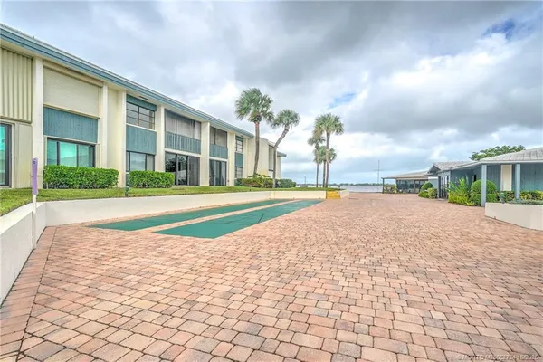 a view of house with swimming pool and yard