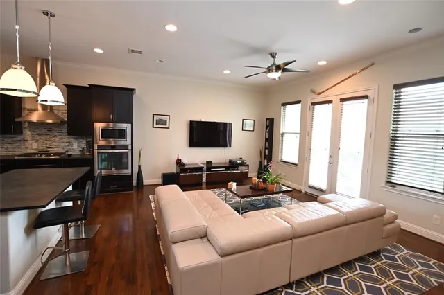 a living room with furniture a large window and a flat screen tv