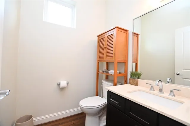 a bathroom with a sink a toilet a mirror and shower