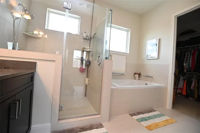a bathroom with a sink a mirror and a shower