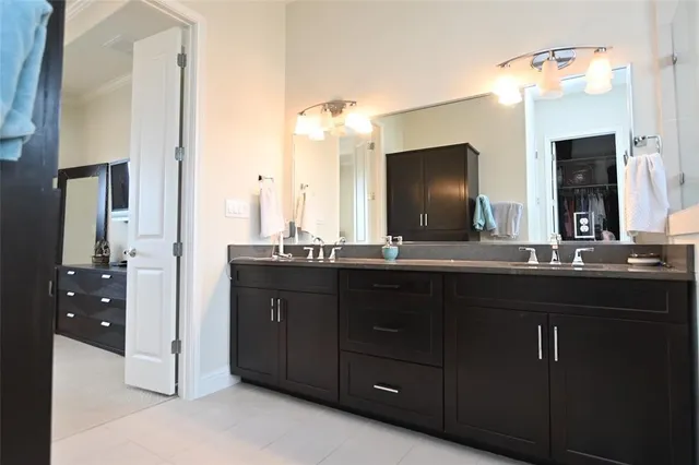 a bathroom with a double vanity sink and a mirror