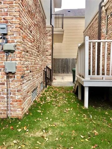 a view of a small house with wooden fence