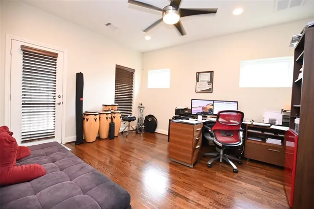 a living room with furniture and wooden floor